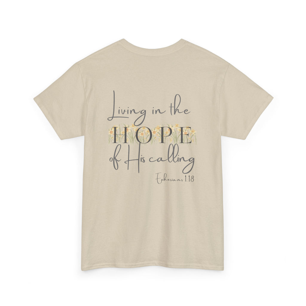 Beige Back of Christian t-shirt displaying the phrase "Living in the Hope of His Calling" with floral daffodil artwork and Ephesians 1:18 scripture reference.