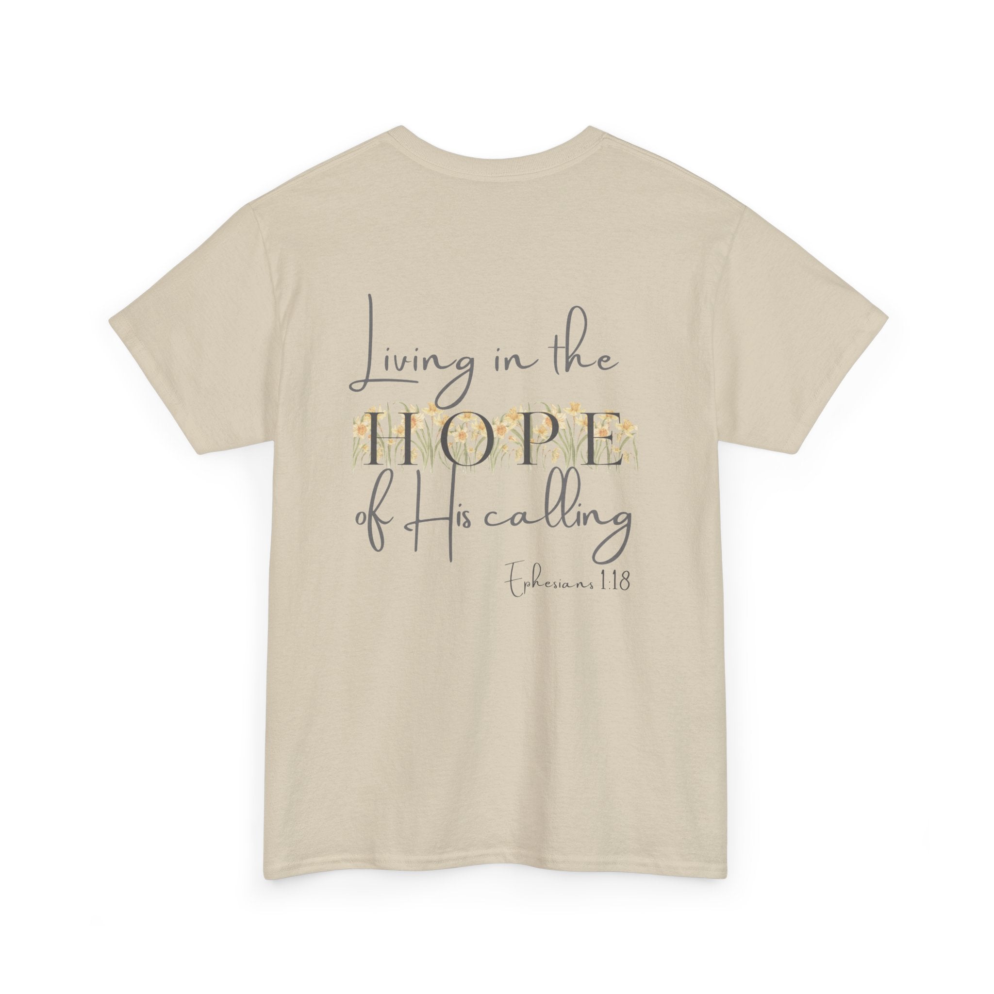 Beige Back of Christian t-shirt displaying the phrase "Living in the Hope of His Calling" with floral daffodil artwork and Ephesians 1:18 scripture reference.