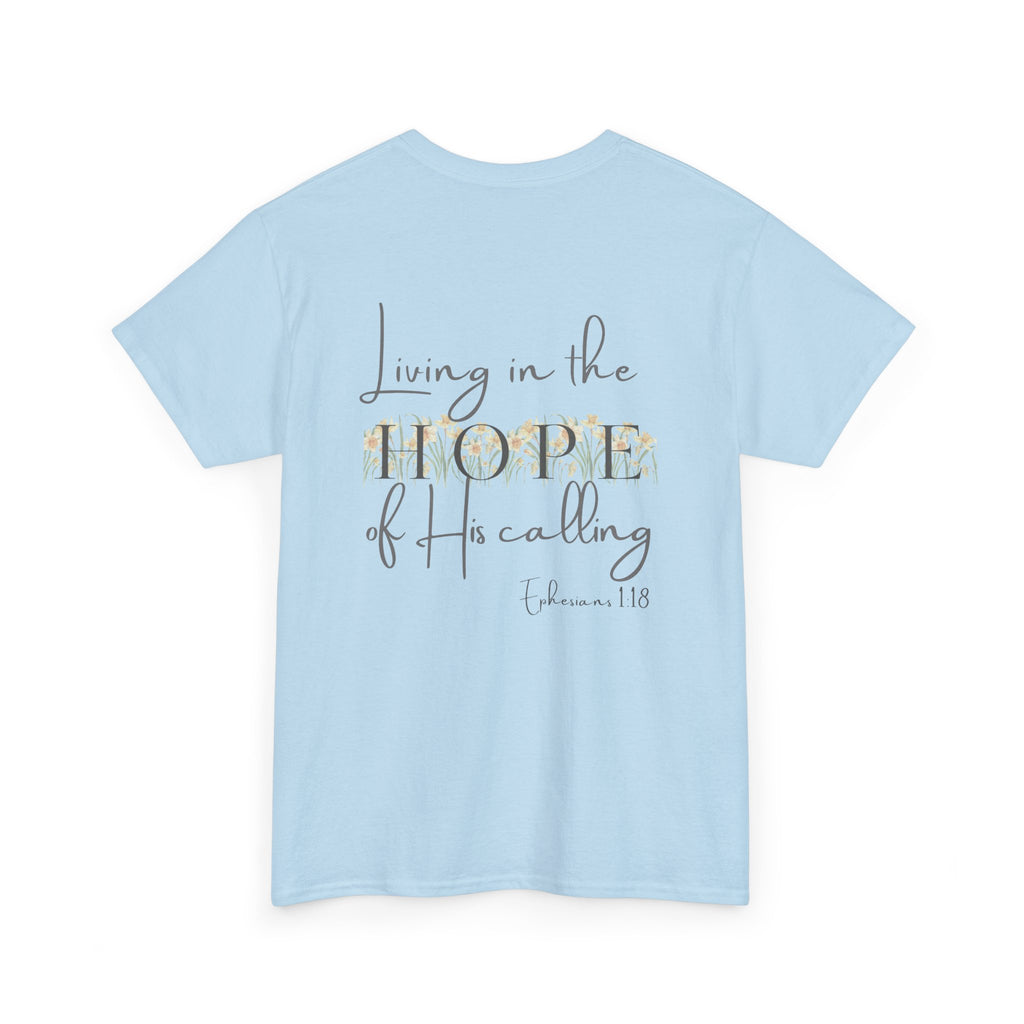 Light Blue Back of Christian t-shirt displaying the phrase "Living in the Hope of His Calling" with floral daffodil artwork and Ephesians 1:18 scripture reference.
