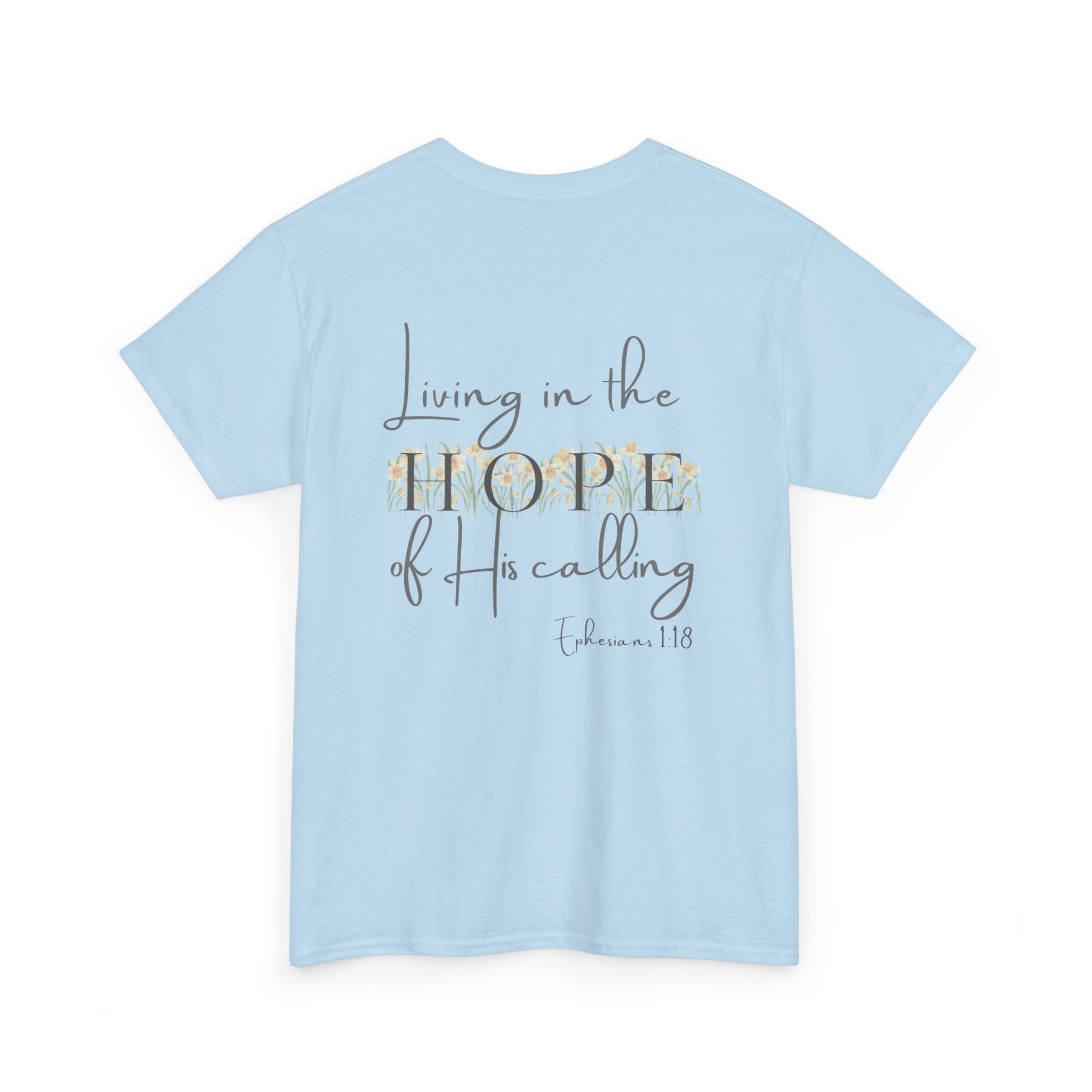 Light Blue Back of Christian t-shirt displaying the phrase "Living in the Hope of His Calling" with floral daffodil artwork and Ephesians 1:18 scripture reference.