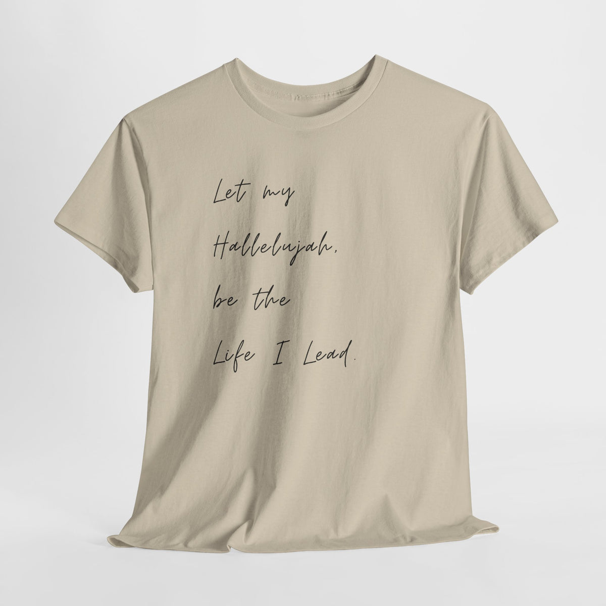 Sand Christian t-shirt featuring the phrase "Let My Hallelujah Be the Life I Lead" in elegant black script on the front.